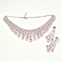 Elegant pink American diamond necklace set with matching long earrings featuring blush pink stones, floral drop accents, and a rhodium-plated finish for bridal and festive wear.