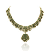 Antique gold-tone green stone statement necklace featuring intricate geometric detailing, sparkling crystal accents, teardrop pendant and matching drop earrings.