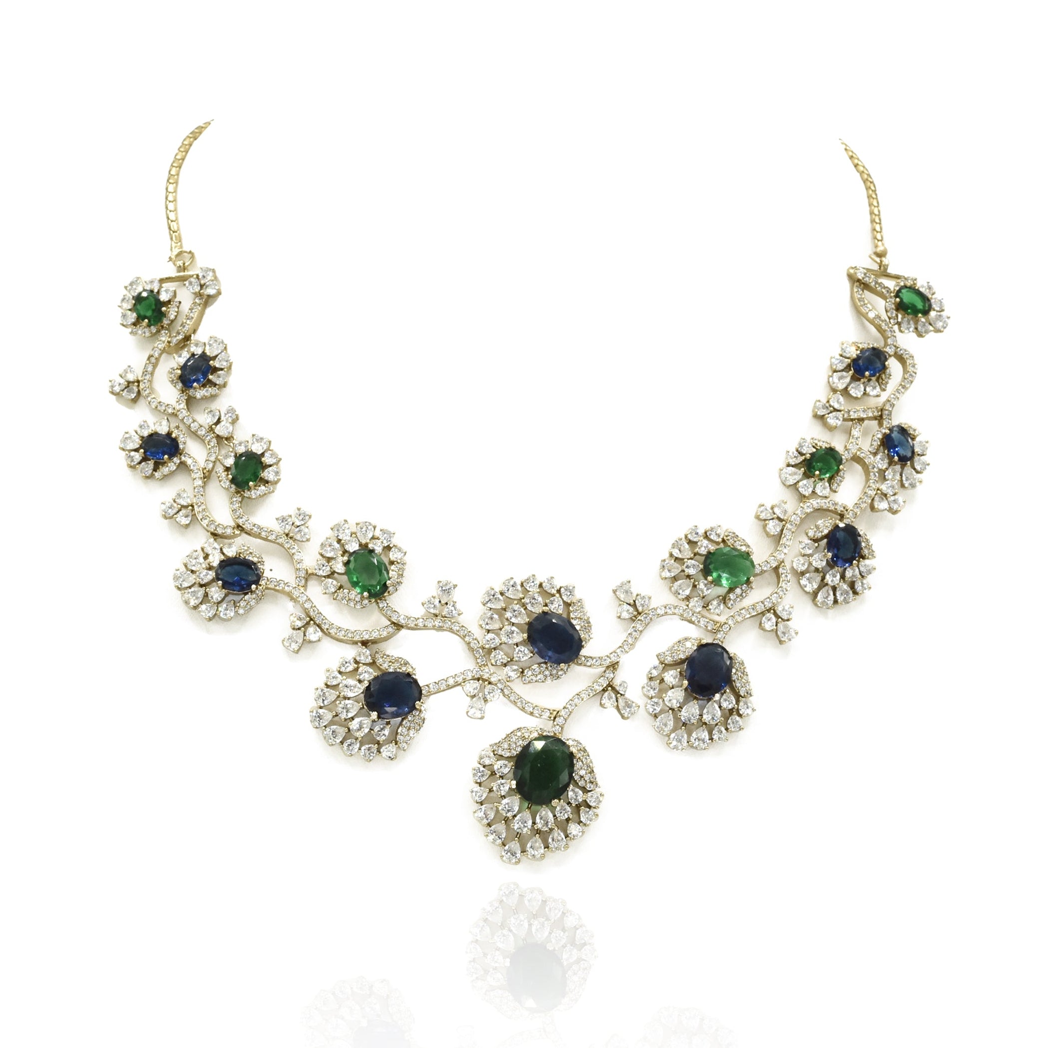 Blue and green American Diamond necklace set with gold-tone floral vine detailing, sparkling clear stones and matching long statement earrings.