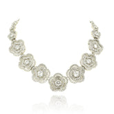 White floral American Diamond necklace set with round and baguette-cut clear stones in a silver-tone finish with matching flower earrings.