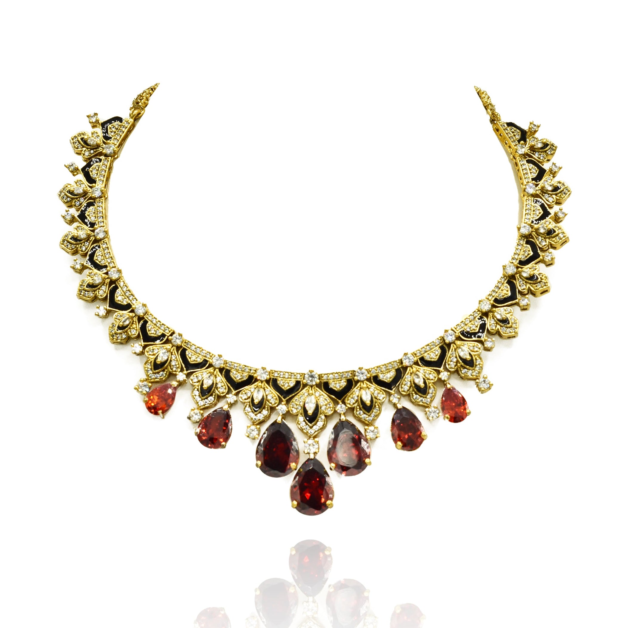 Gold-tone necklace set with black enamel detailing, sparkling clear accents, deep orange teardrop stones and matching statement earrings.