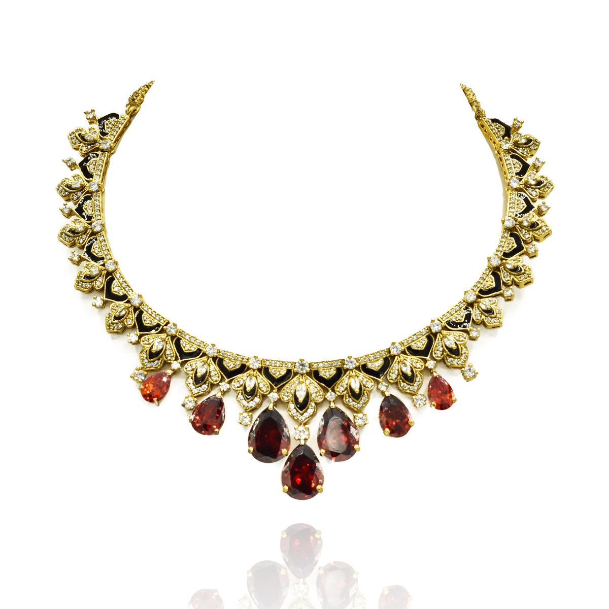 Gold-tone necklace set with black enamel detailing, sparkling clear accents, deep orange teardrop stones and matching statement earrings.