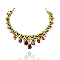 Gold-tone necklace set with black enamel detailing, sparkling clear accents, deep orange teardrop stones and matching statement earrings.
