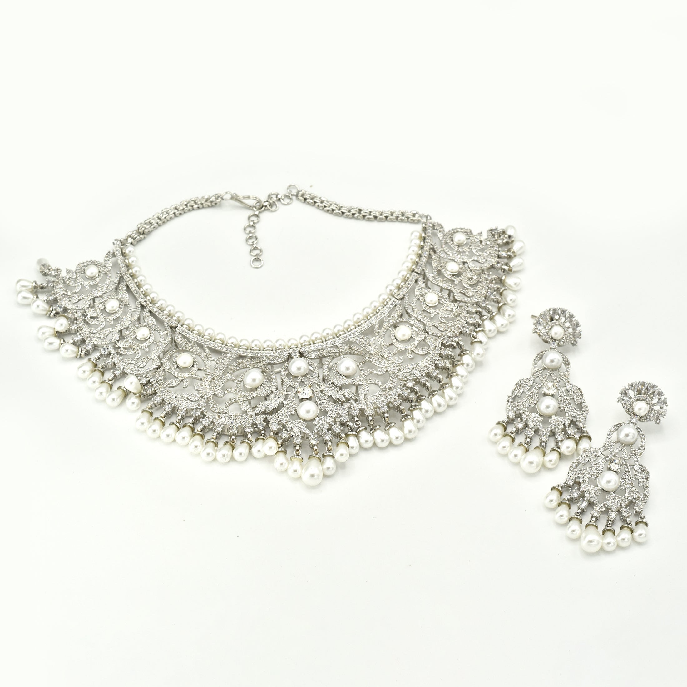 Silver-tone American Diamond choker necklace set with intricate floral detailing, white pearl accents, cascading pearl drops and matching earrings.
