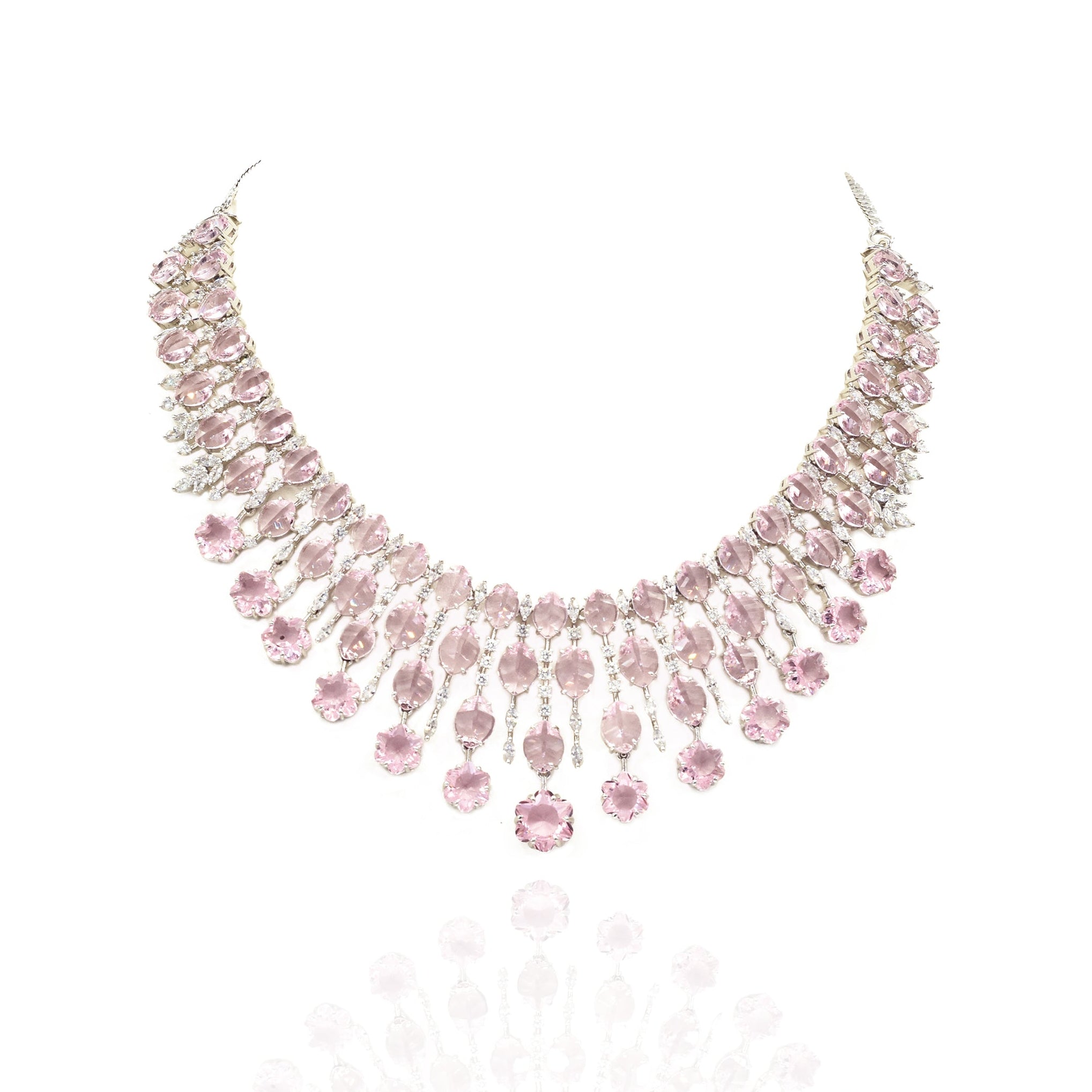 Elegant pink American diamond necklace set with matching long earrings featuring blush pink stones, floral drop accents, and a rhodium-plated finish for bridal and festive wear.