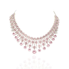 Elegant pink American diamond necklace set with matching long earrings featuring blush pink stones, floral drop accents, and a rhodium-plated finish for bridal and festive wear.