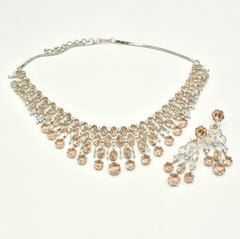 Elegant champagne American diamond necklace set with matching long earrings featuring  floral drop accents, and a rhodium-plated finish for bridal and festive wear.