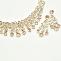 Elegant champagne American diamond necklace set with matching long earrings featuring  floral drop accents, and a rhodium-plated finish for bridal and festive wear.