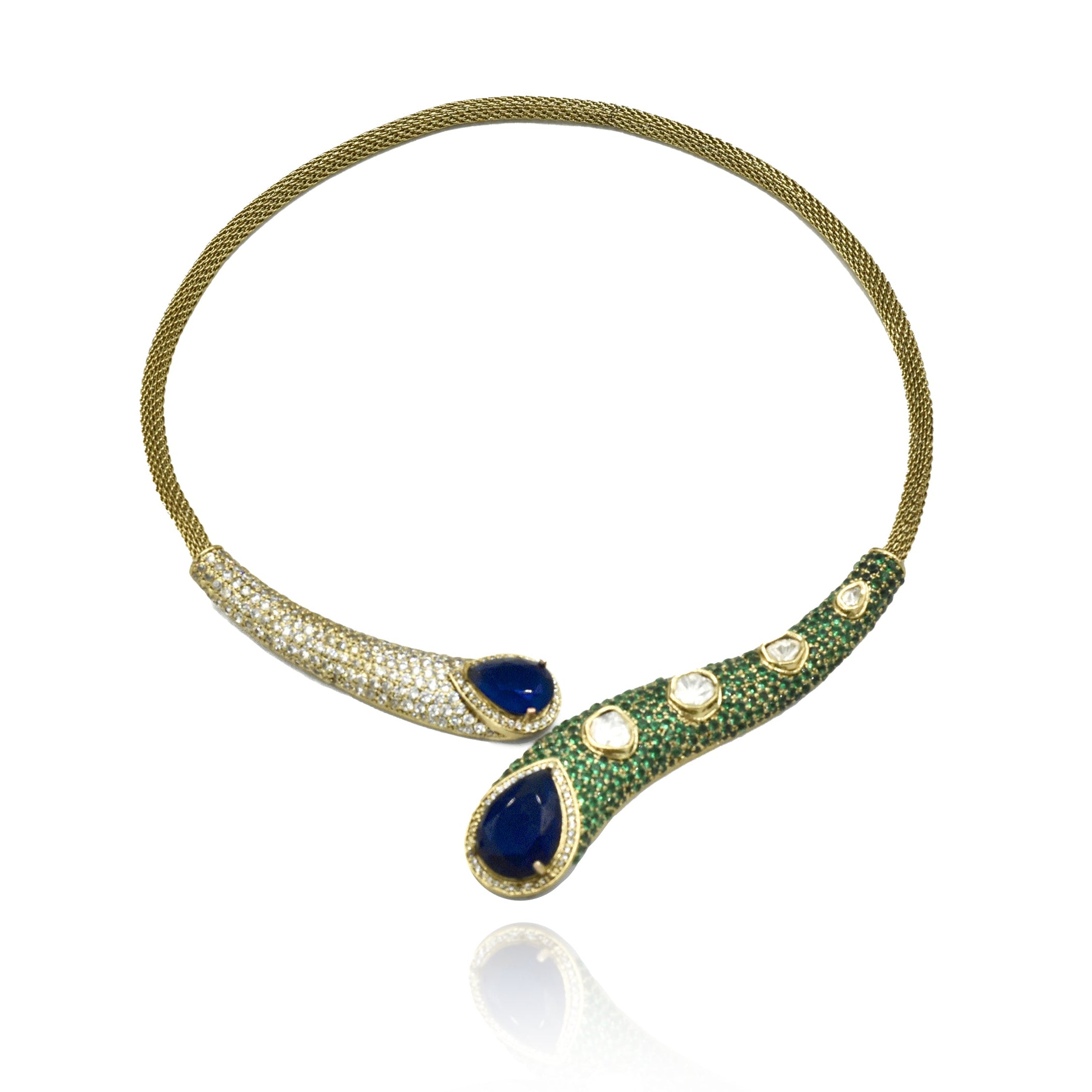 Contemporary gold-tone Hasli necklace set with deep blue teardrop stones, green pavé-style detailing, Kundan-inspired accents and matching long earrings.