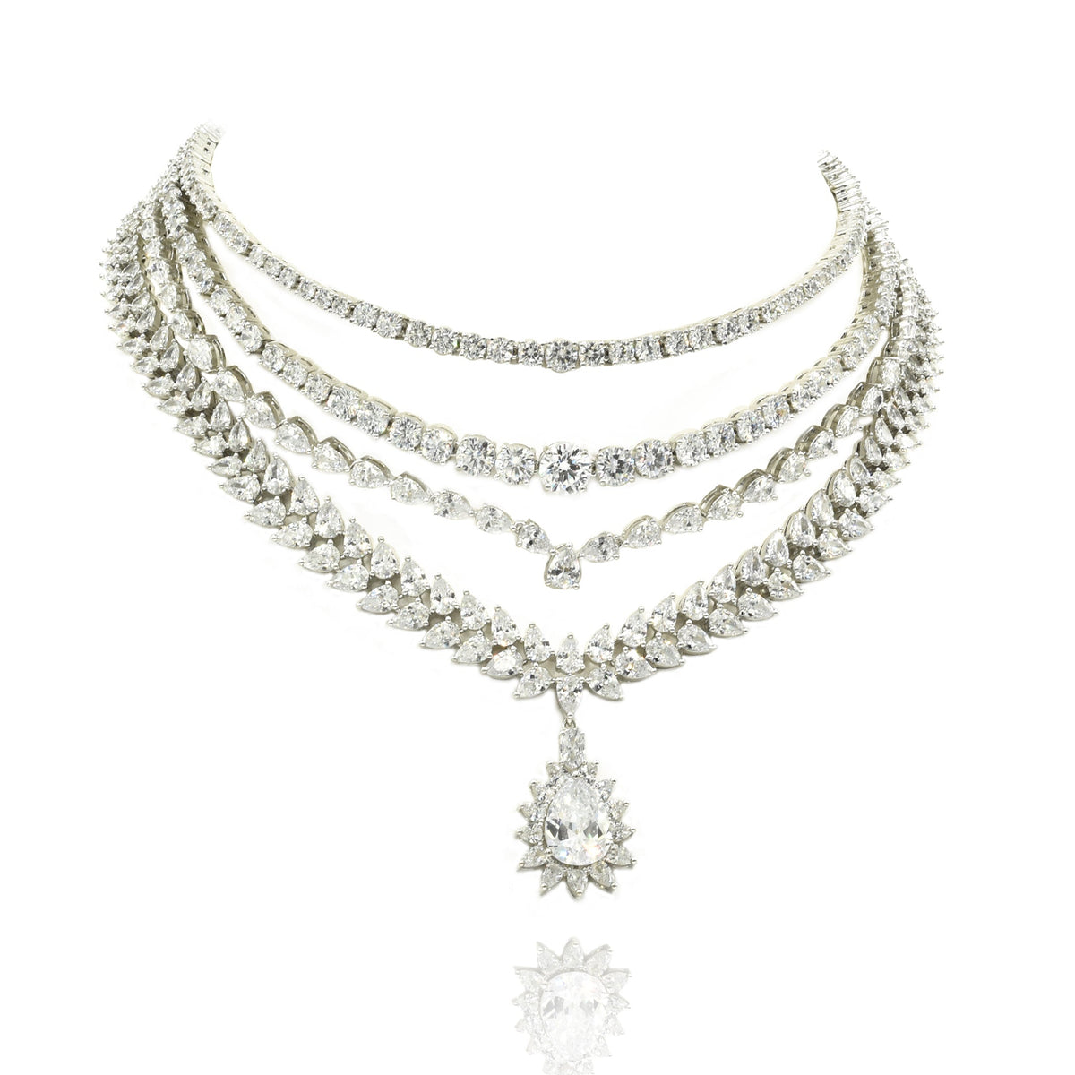 Four-layer American Diamond necklace set with clear CZ stones, teardrop starburst centerpiece and matching long statement earrings.
