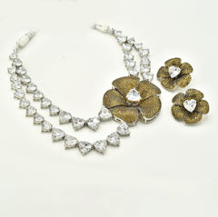 Double-layer American Diamond necklace with heart-shaped clear stones, oversized gold-tone floral centerpiece and matching statement flower earrings.