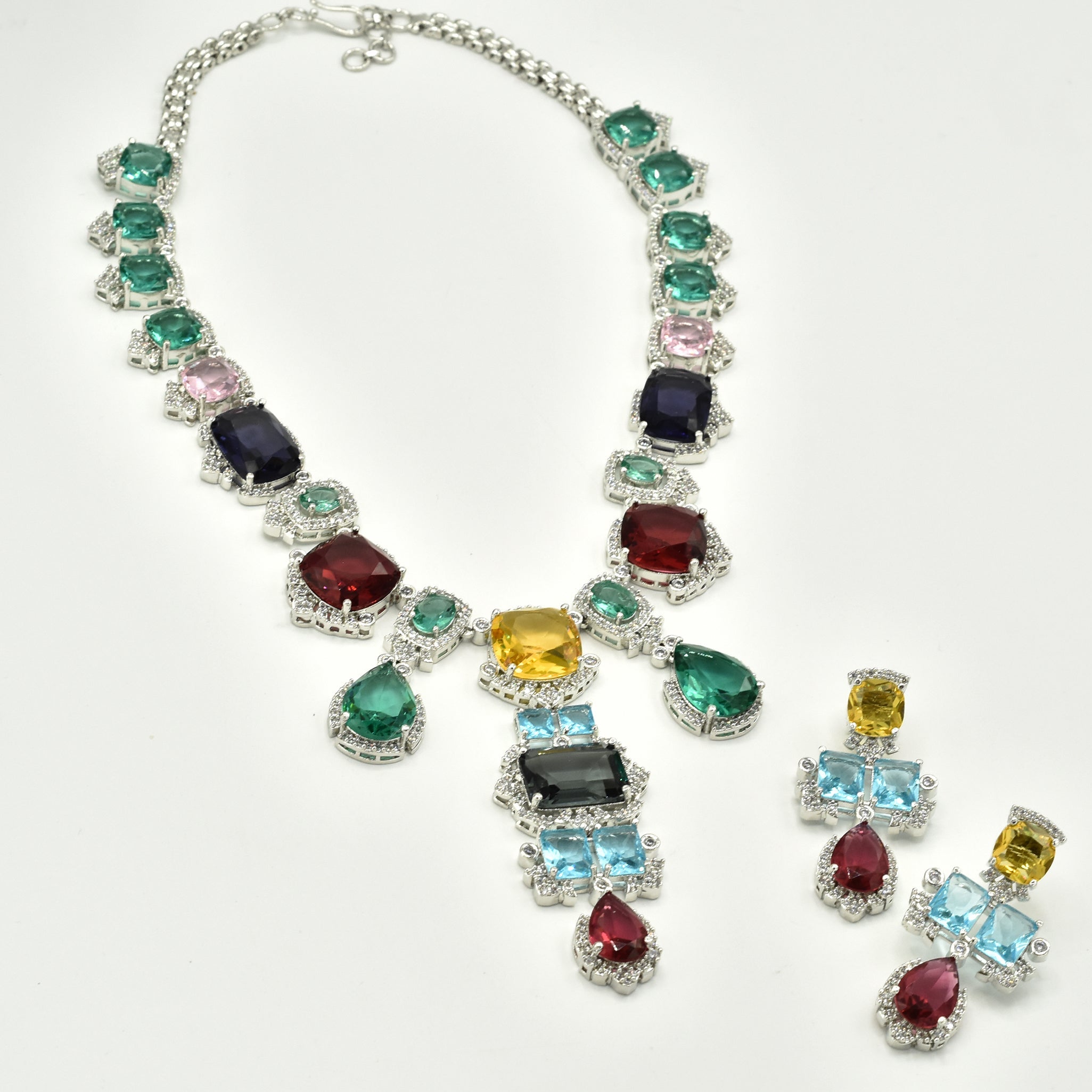 Multicolor statement necklace set with green, blue, pink, yellow, aqua, and wine stones in a silver-tone setting with matching drop earrings.