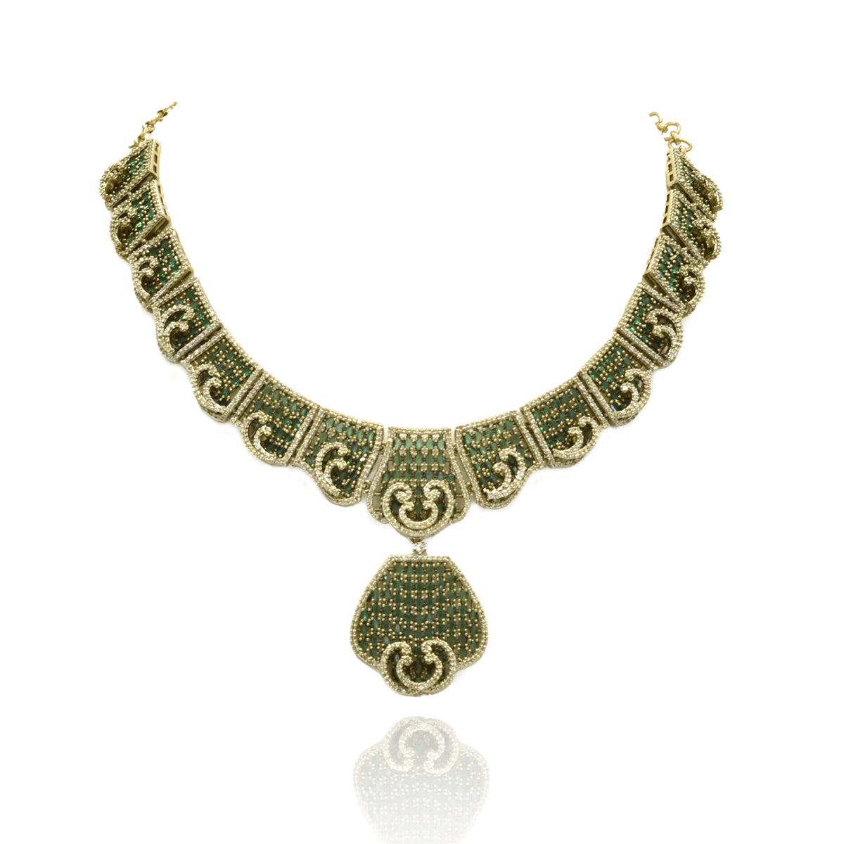 Antique gold-tone green stone statement necklace featuring intricate geometric detailing, sparkling crystal accents, teardrop pendant and matching drop earrings.