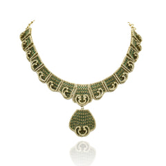 Antique gold-tone green stone statement necklace featuring intricate geometric detailing, sparkling crystal accents, teardrop pendant and matching drop earrings.