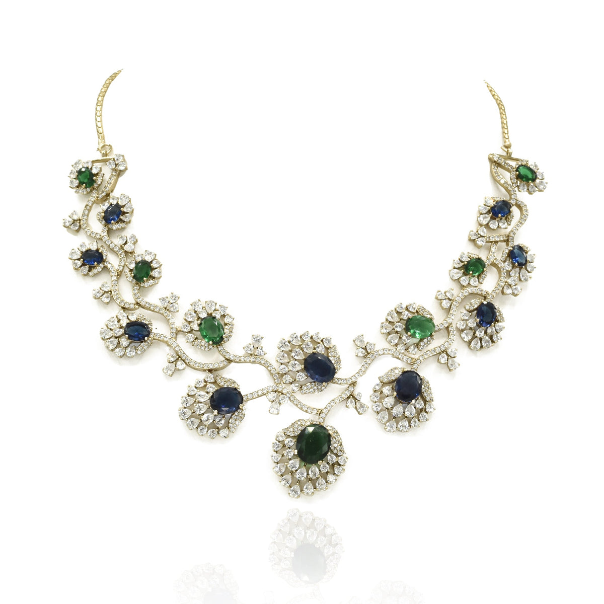 Blue and green American Diamond necklace set with gold-tone floral vine detailing, sparkling clear stones and matching long statement earrings.