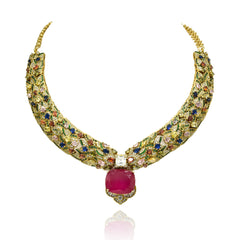 Gold-tone multicolor statement necklace set with intricate jewel-tone stones, bold deep pink center stone and matching pink statement earrings.