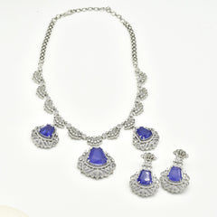 Purple American Diamond statement necklace set with three violet-purple stone drops, intricate silver-tone crystal detailing, and matching statement earrings.