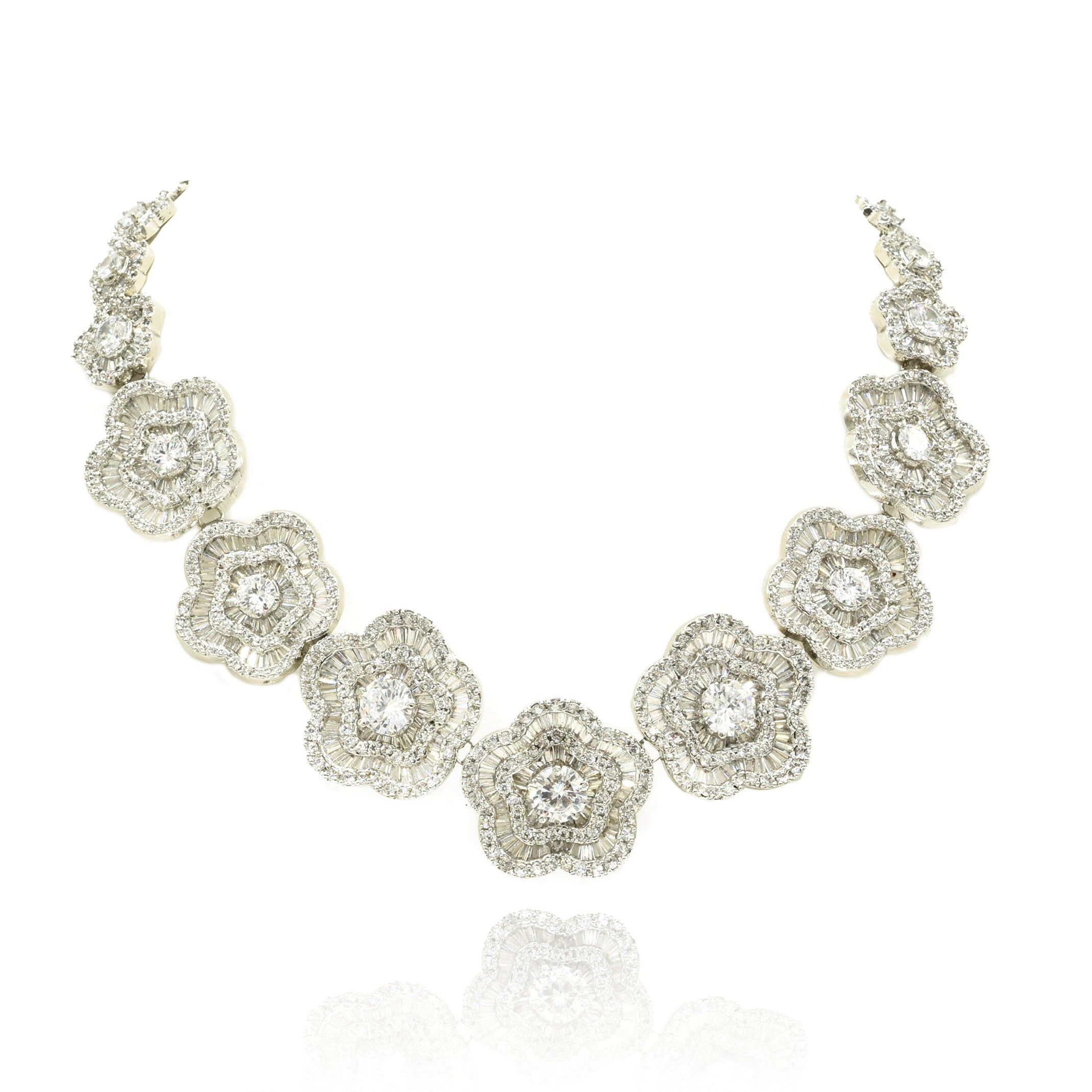White floral American Diamond necklace set with round and baguette-cut clear stones in a silver-tone finish with matching flower earrings.