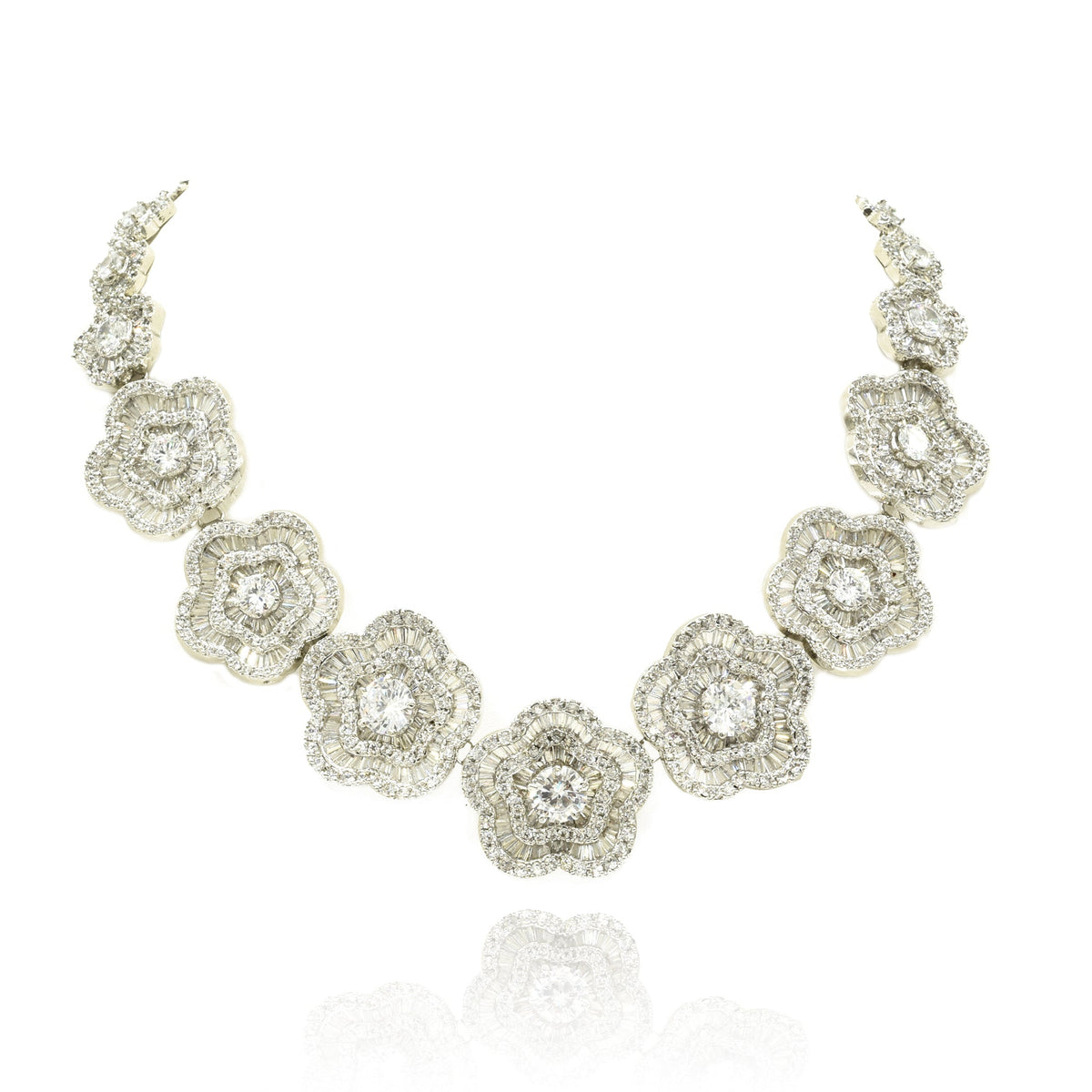 White floral American Diamond necklace set with round and baguette-cut clear stones in a silver-tone finish with matching flower earrings.